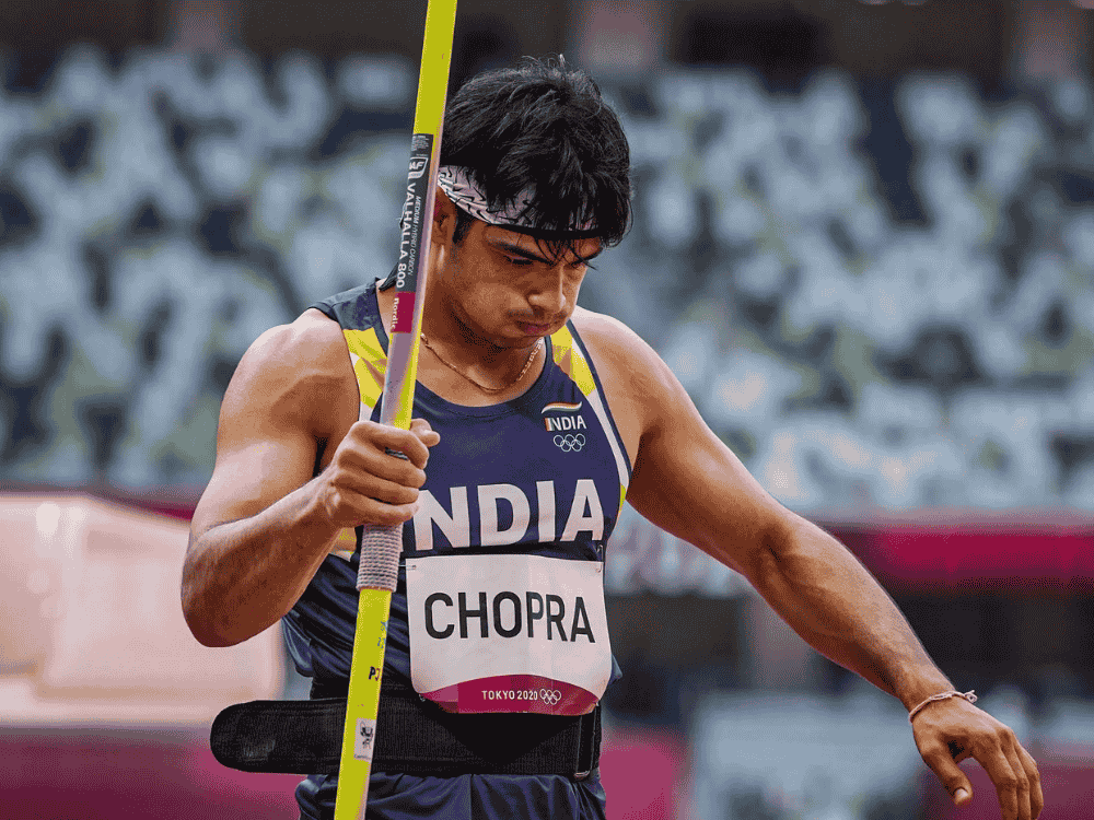 Neeraj Chopra wearing India jersey, holding javelin in hand during Tokyo 2021 — now under criticism for inviting Arshad Nadeem.