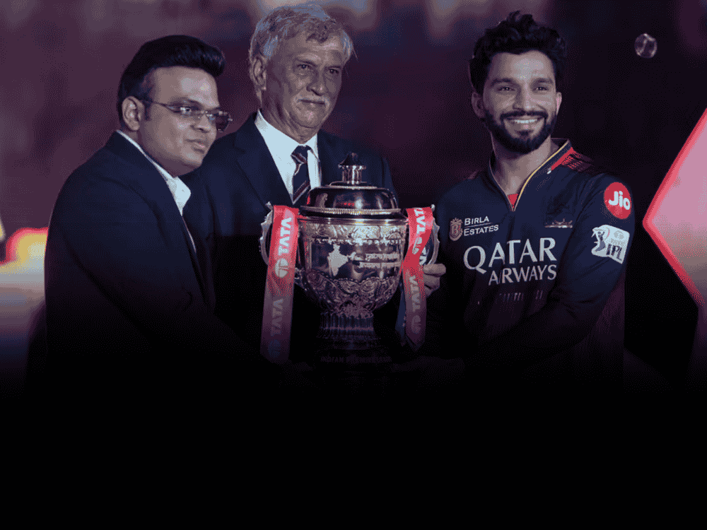 Image showing BCCI Secretary Jay Shah presenting the IPL 2025 trophy to RCB captain Rajat Patidar after their maiden title win; highlights the success of IPL, which contributed majorly to BCCI’s ?9,742 crore earnings in FY 2023-24. Ask ChatGPT