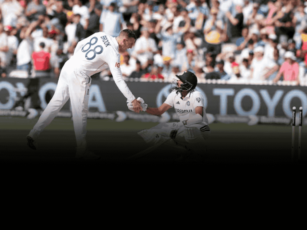 Mohammed Siraj sitting dejected near the pitch after being bowled out in the final innings of the third Test at Lord’s, as England's Harry Brook consoles him with a handshake following India’s narrow 22-run defeat.